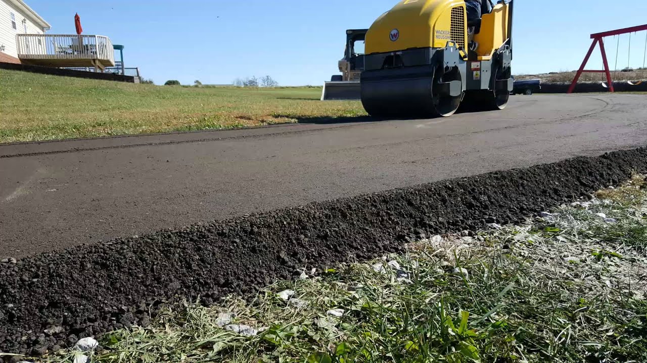 Roller compacting a repaired asphalt edge