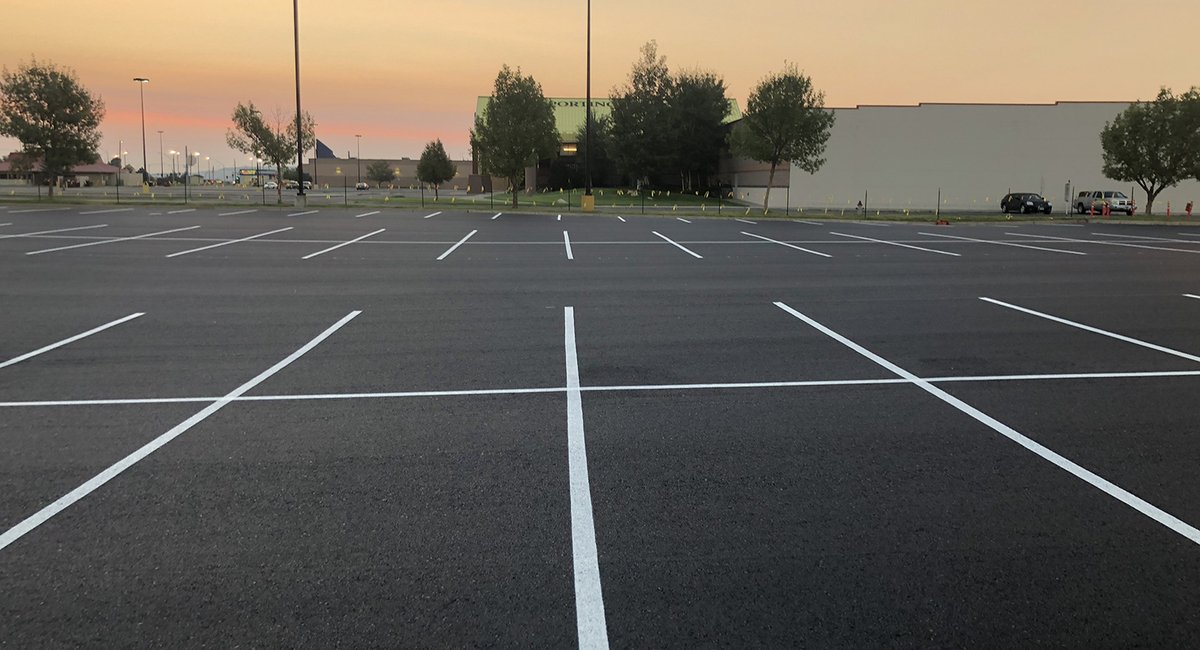 Freshly striped commercial parking lot at dusk
